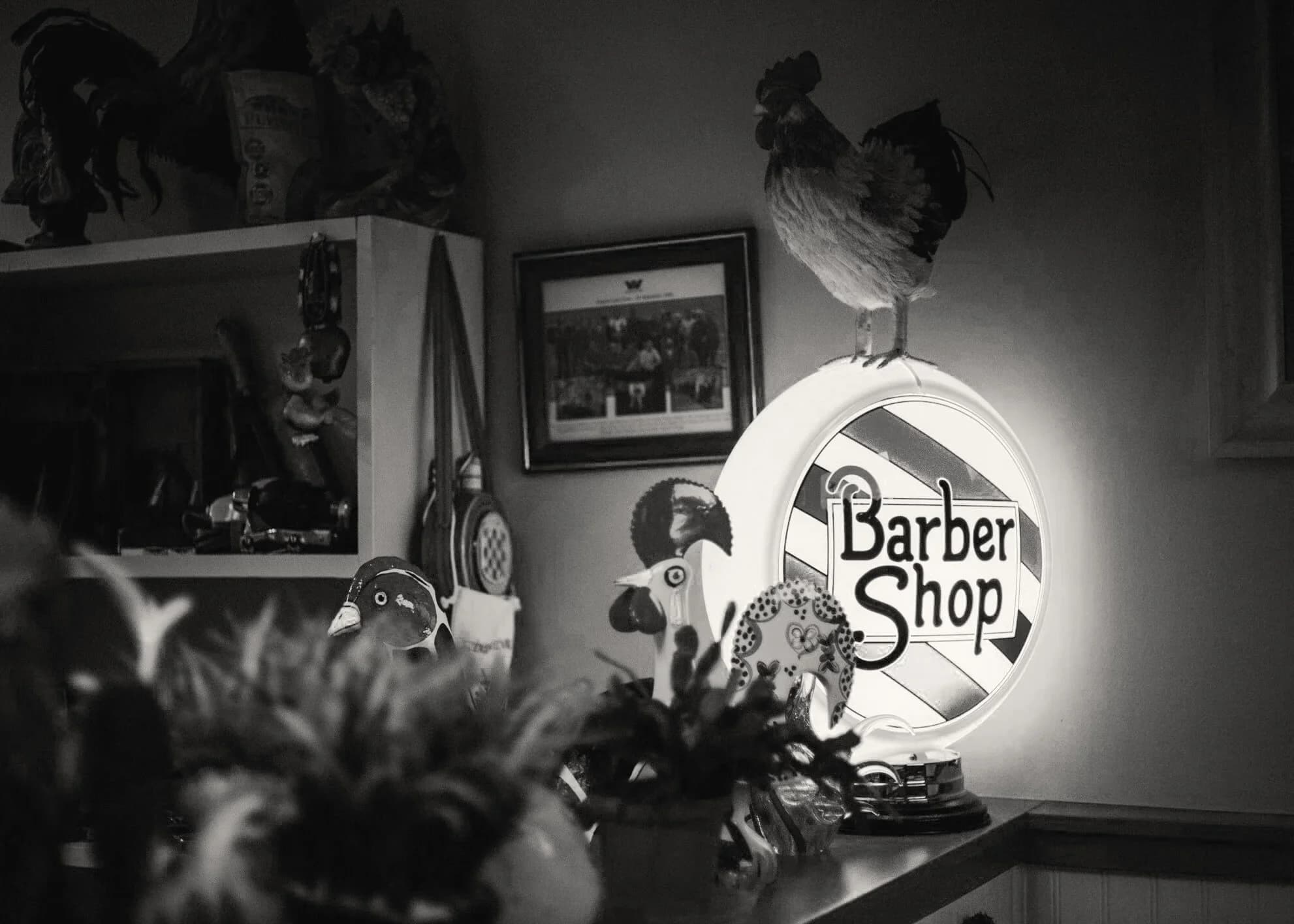 Rooster’s Barbershop interior and illuminated barber shop sign